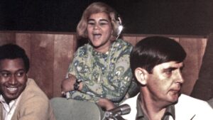 MUSCLE SHOALS AL - CIRCA 1967: R and B singer Etta (at back) and studio owner Rick Hall (right) recording at Fame Studios circa 1967 in Muscle Shoals, Alabama. (Photo by House Of Fame LLC/Michael Ochs Archive/Getty Images)